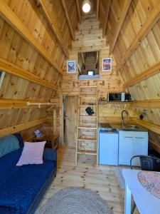 a log cabin with a kitchen and a sink in it at Tipi Big Foot in Vivy