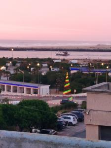 a large colorful christmas tree in a parking lot at Beach House B2 in Kenitra