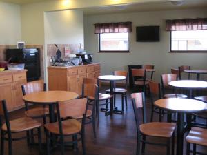 a restaurant with tables and chairs and a kitchen at Trade winds in Valentine +4 photos