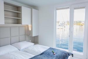 a bedroom with a bed with a view of the water at Floating Sea House Portorose in Portorož +45 photos