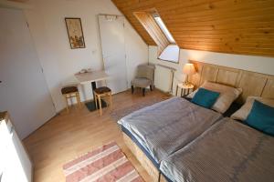 a bedroom with a bed and a desk in a room at Penzión Belvia in Nová Lesná