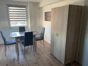 a room with a table and chairs and a cabinet at Ferienwohnung Ulsteraue in Geisa