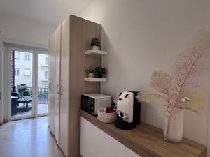 a kitchen with a counter with a coffee maker and plants at TERRACINA Central Rooms in Terracina +21 photos