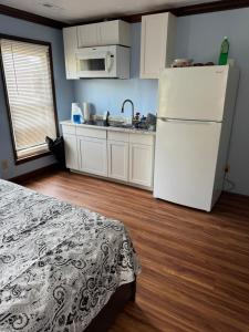 a kitchen with a white refrigerator and a wooden floor at Studio with jacuzzi near Atlantic ocean in Myrtle Beach