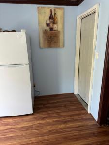 a room with a refrigerator and a door with wine bottles on the wall at Studio with jacuzzi near Atlantic ocean in Myrtle Beach