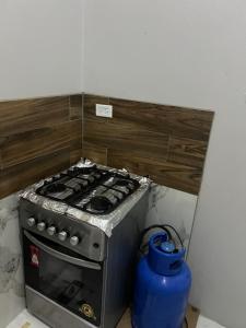 a stove in a kitchen with a blue pot at Op paradise living in Kingston