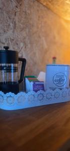 a tray with a coffee maker and other items on a table at Cozy Cow Farm Lodge in Lucerne +15 photos