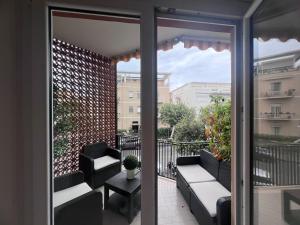 a balcony with a couch and a table and chairs at TERRACINA Central Rooms in Terracina
