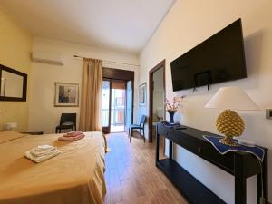 a bedroom with a large bed with a television on the wall at millennium holiday in Castellammare del Golfo