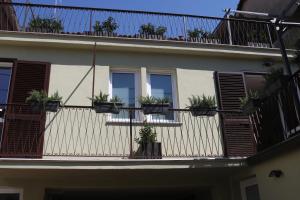 a balcony with a bunch of potted plants on it at Casa Vacanza del Palio 2 in Nizza Monferrato