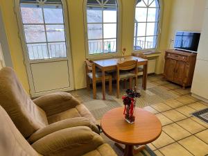 a living room with a couch and a table at Ferienwohnung 2 in Bernkastel-Kues +6 photos