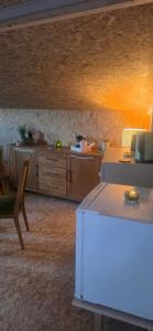 a living room with a table and a counter at Cozy Cow Farm Lodge in Lucerne