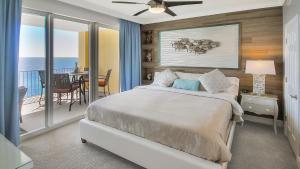 a bedroom with a bed and a balcony at Luxury Vacation Escape Free Beach Service Come Relax Book Now! in Panama City Beach