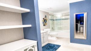 a bathroom with a toilet and a glass shower at Luxury Vacation Escape Free Beach Service Come Relax Book Now! in Panama City Beach +26 photos