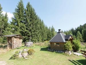 a cabin in the middle of a field with trees at Peaceful Stay in Jägersgrün in Bad Reiboldsgrün