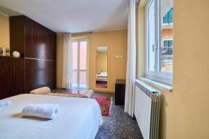 a hotel room with a bed and a window at Doretta's House - Luxury Apartment in Noli