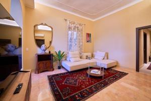 a living room with a white couch and a mirror at Doretta's House - Luxury Apartment in Noli