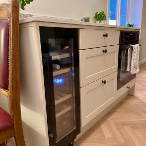 a kitchen island with a black refrigerator in it at Oslo, Classic Apartment in Oslo