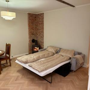 a bed in a room with a brick wall at Oslo, Classic Apartment in Oslo
