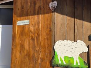 a wooden door with a sheep painted on it at Cozy Cow Farm Lodge in Lucerne