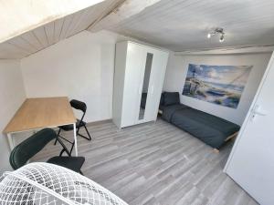a room with a bed and a desk and a table at Geneva House G in Ferney-Voltaire +5 photos