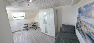 a bedroom with a bed and a desk and a window at Geneva House G in Ferney-Voltaire