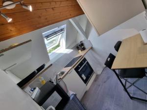 an overhead view of an office with a desk and a table at Geneva House G in Ferney-Voltaire