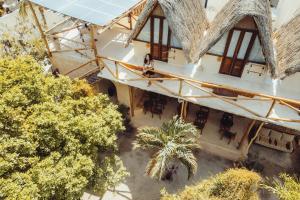 an overhead view of a building with chairs and trees at Casa Balam Holbox, Beach style cabañas in Holbox Island
