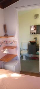a bathroom with a toilet and a sink in a room at Posada IRSIS in La Pedrera +89 photos