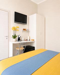 a bedroom with a bed and a tv on a wall at Il Quadrifoglio guesthouse in La Spezia