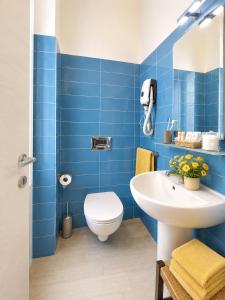 a blue bathroom with a toilet and a sink at Il Quadrifoglio guesthouse in La Spezia +26 photos