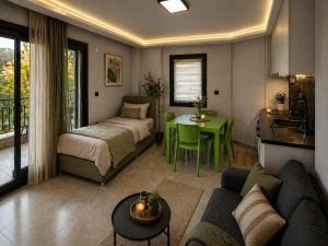 a living room with a couch and a bed and a table at Taşhan Apart Otel in Didim +15 photos