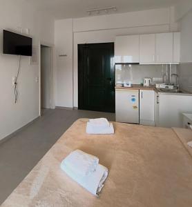 a kitchen with two white towels on the floor at Rena Studios in Paleokastritsa +96 photos