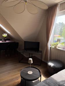 a room with a bed and a table and a tv at TheSlowMorningNo1 in Cuxhaven