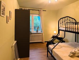 a bedroom with a bunk bed and a window at TheSlowMorningNo1 in Cuxhaven