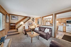 a living room with a couch and a table at Trapper 8: Cozy 4-Bedroom Condo, 1 Minute to Yellowstone, perfect for 8 guests. in Levokumskoye