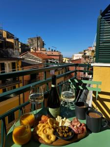 a table with a plate of food and wine glasses at Ca' De Carme' in Riomaggiore