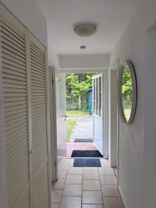 an open hallway with a door and a mirror at Strandkorb 115 in Rostock