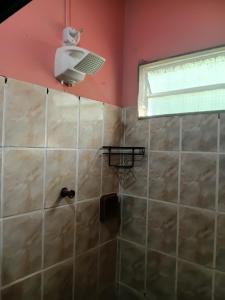 a bathroom with a shower with a shower head at Casa de Família Coração Amazônico in Alter do Chao +33 photos