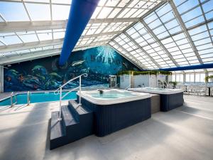 a large bathroom with two jacuzzis in a building at Bolero Resort in Wildwood