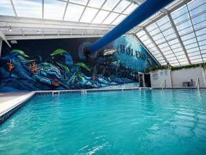 a swimming pool with a mural on the wall at Bolero Resort in Wildwood