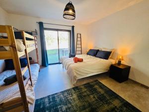 a bedroom with two bunk beds and a ladder at Mas des châtaigniers in Le Vigan