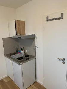 a small kitchen with a sink and a refrigerator at Apartments Adelheid in Wathlingen