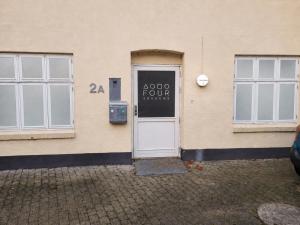 a door of a building with a sign on it at 4SEASONS - Golden Spring Suite in Aalborg
