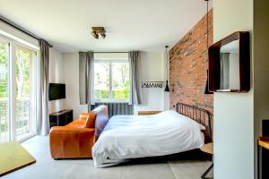 a bedroom with a bed and a brick wall at Appartamenti 1 in Dervio