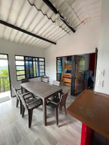 a dining room with a wooden table and chairs at Casa campestre Shalom in Vergara