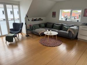 a living room with a couch and a table at Kystvejen 40F in Hadsund
