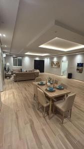 a living room with a table and chairs and a couch at شاليه لافندر ينبع in Yanbu Al Bahr