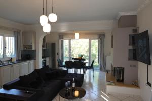 a living room with a black couch and a table at Ionian Juliet Villas in Kothoníkion