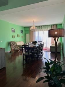 a living room with a table and chairs and a couch at House Tramonto D'oro in Ficulle